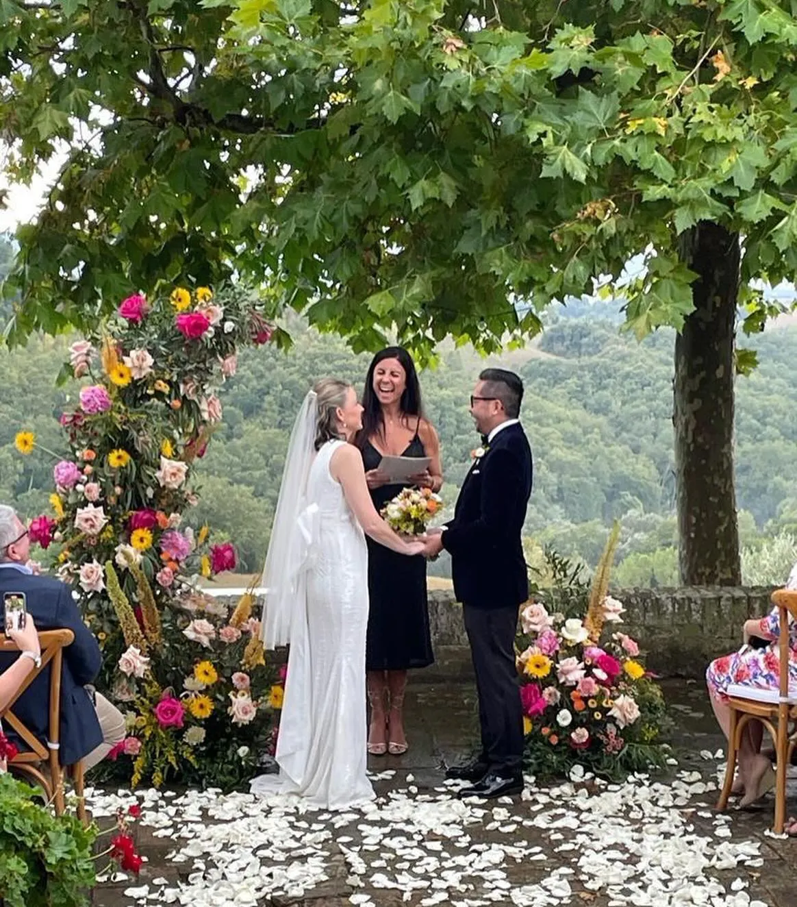 Every ceremony comes with Celebrant laughing with the couple under a plane tree with colourful flowers