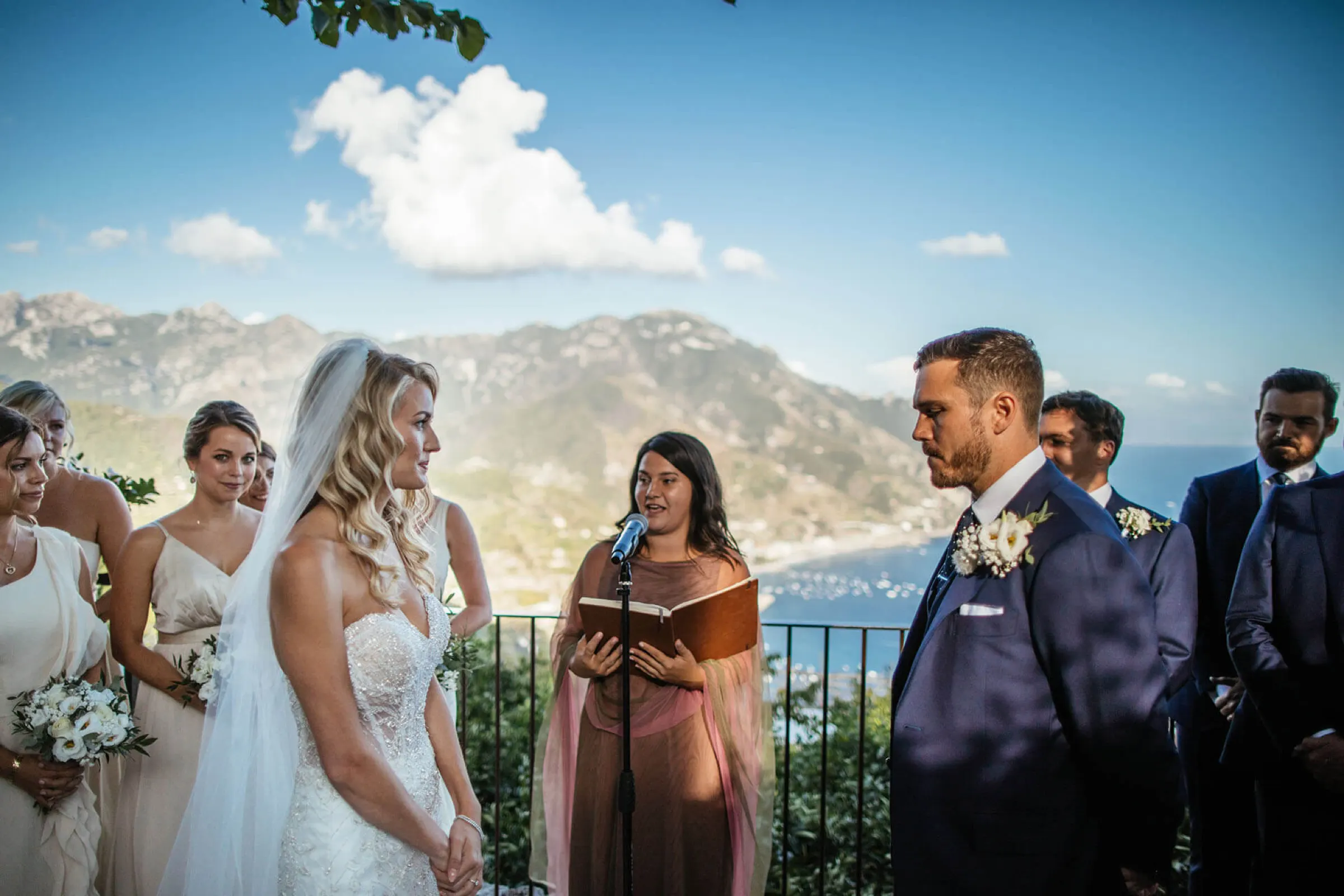 Celebrant speaking during a wedding ceremony with a view of the Amalfi Coast Celebrant speaking during a wedding ceremony with a view of the Amalfi Coast