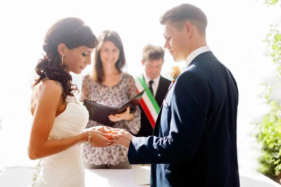 For a civil ceremony we Ring exchange at a civil wedding with the celebrant and the officiant wearing the tricolour sash