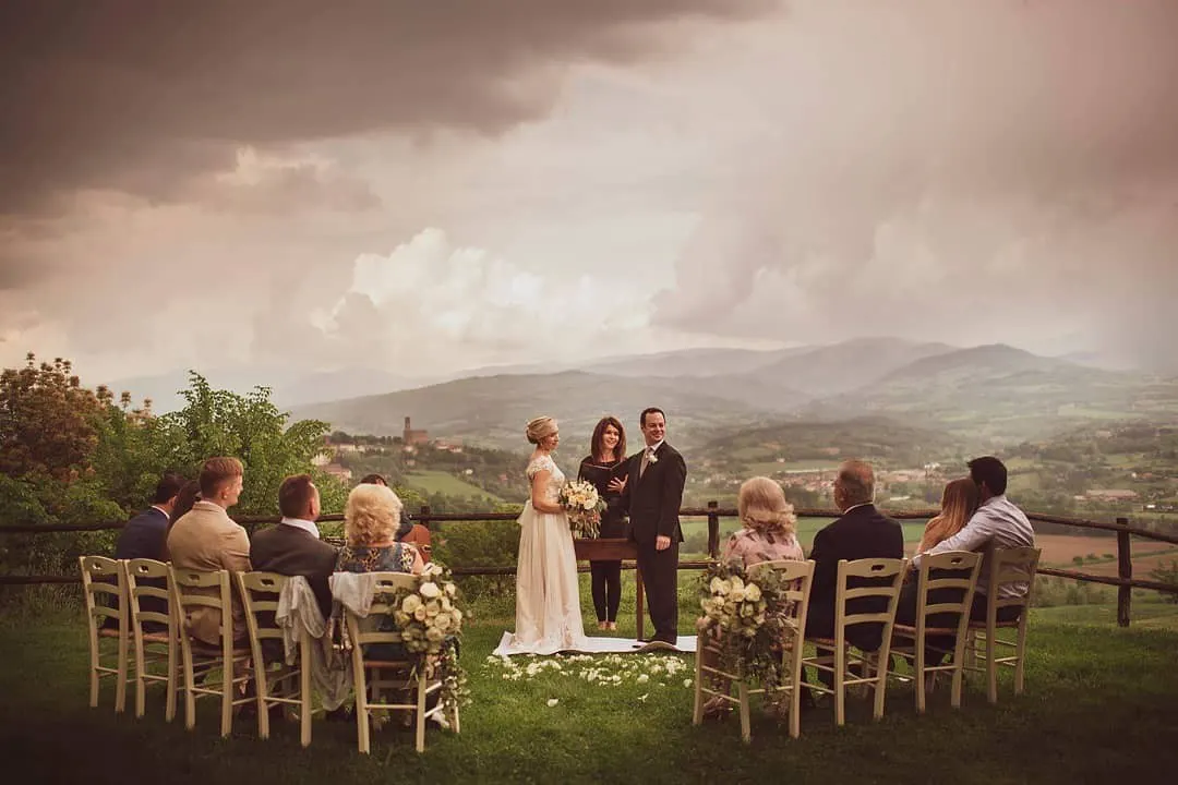Every ceremony comes with Intimate wedding ceremony on a hilltop lawn under a stormy sky, with Poppi in the Casentino in the background