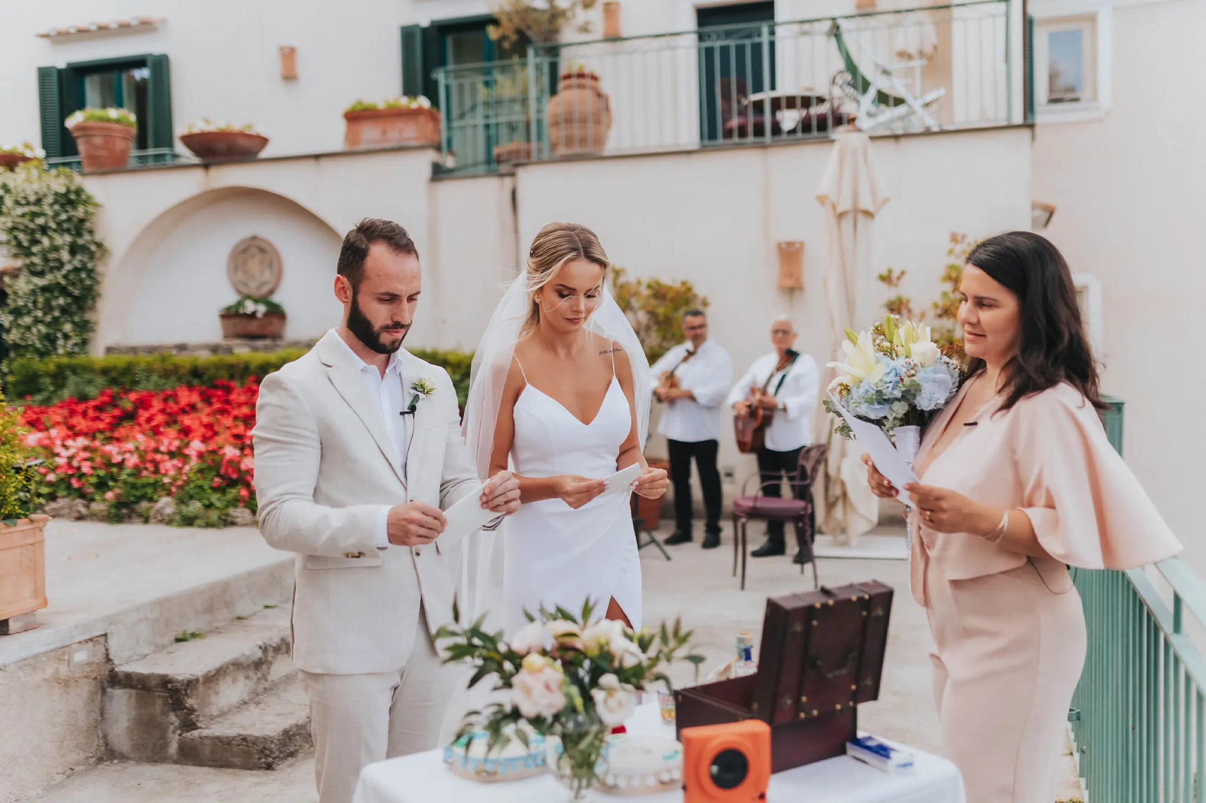 Couple listening to their celebrant during a wedding ceremony in a villa garden on the Amalfi Coast Couple listening to their celebrant during a wedding ceremony in a villa garden on the Amalfi Coast
