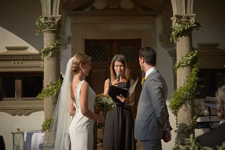 Translations - Efffetti Celebrant reading the ceremony under a villa loggia in Chianti