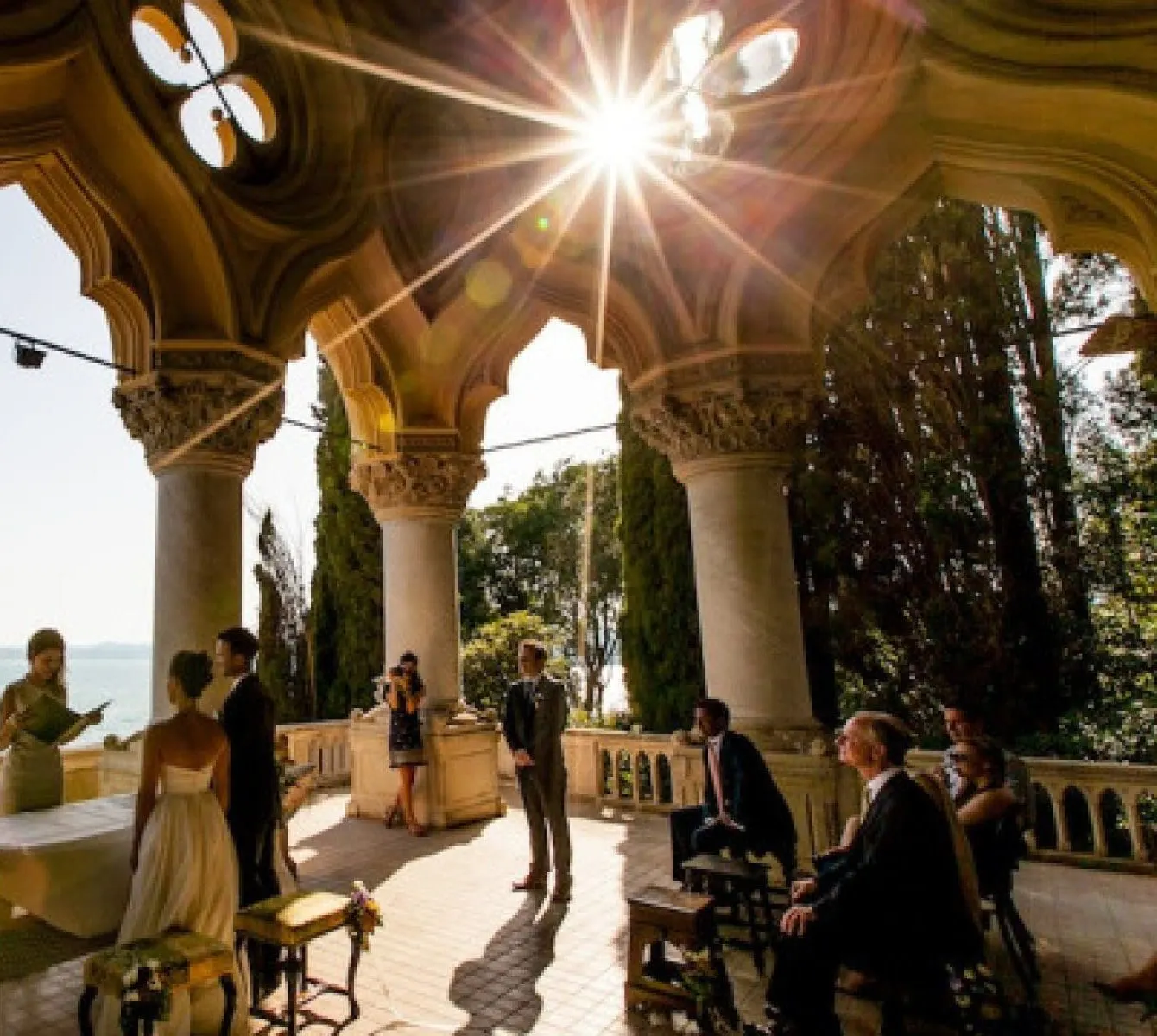 The Lakes Wedding ceremony under a Gothic loggia overlooking Lake Garda