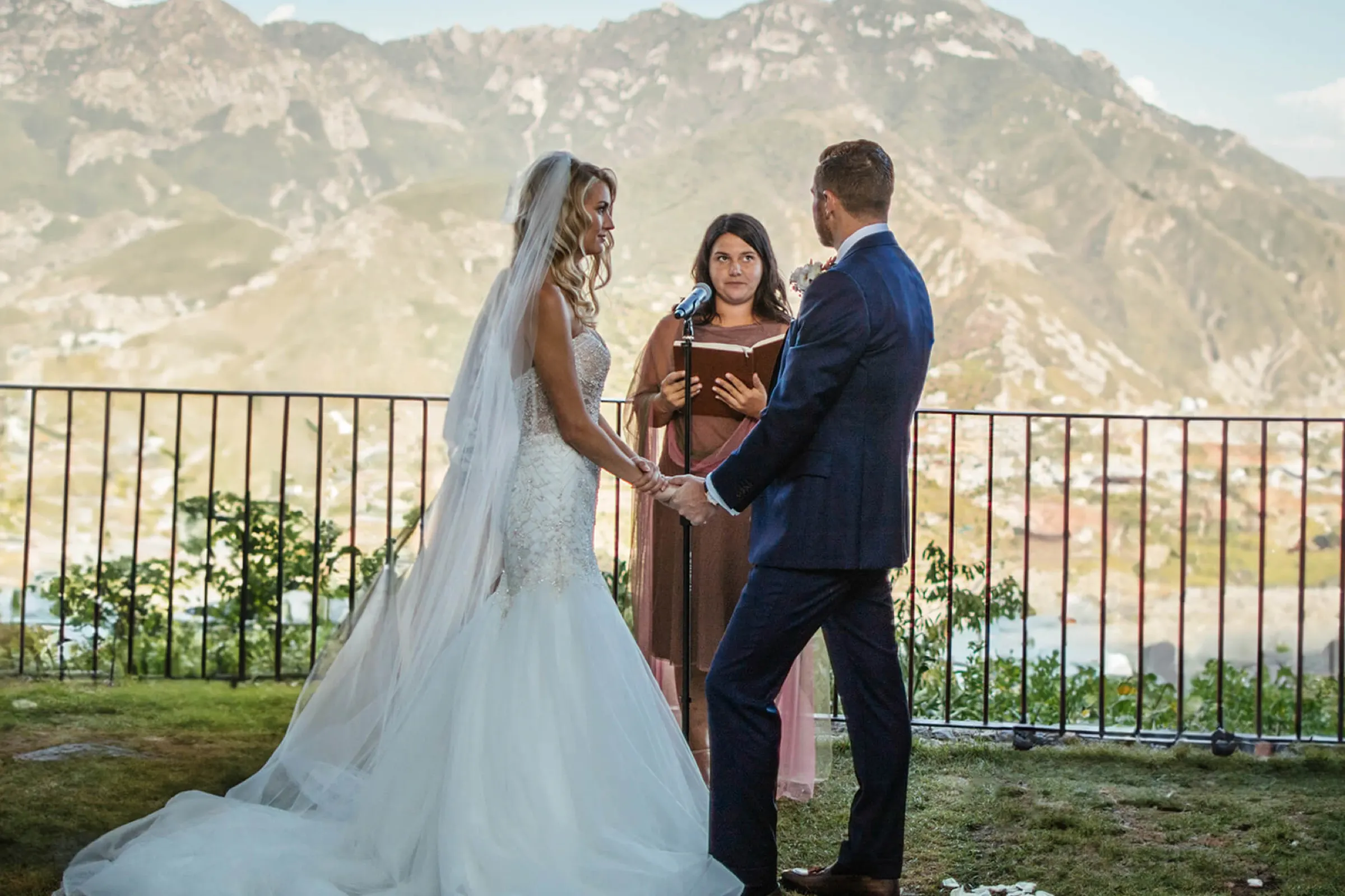 Elopements Couple exchanging vows with their celebrant on a terrace above the sea on the Amalfi Coast