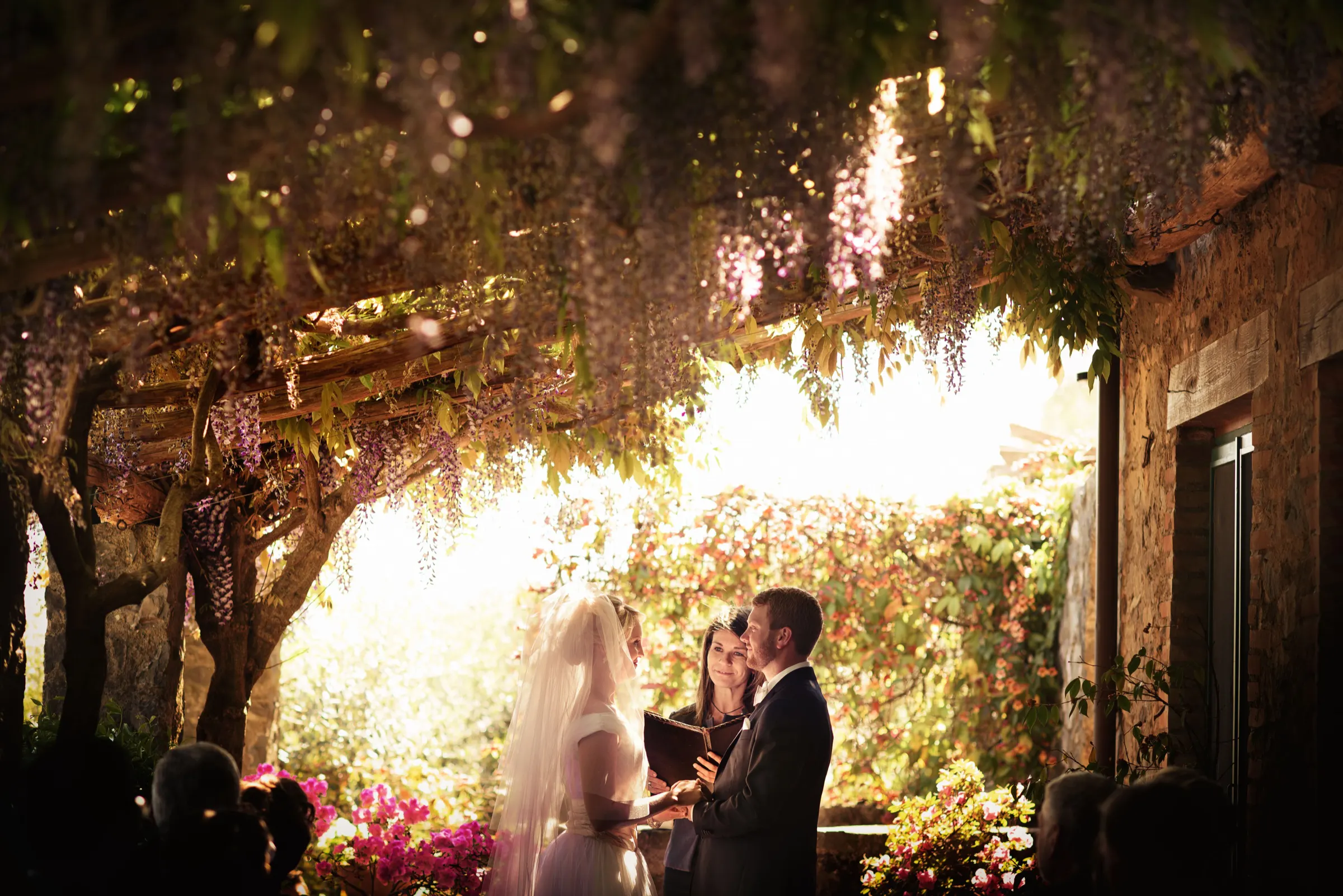 Wedding ceremony under a wisteria pergola in Italy Wedding ceremony under a wisteria pergola in Italy