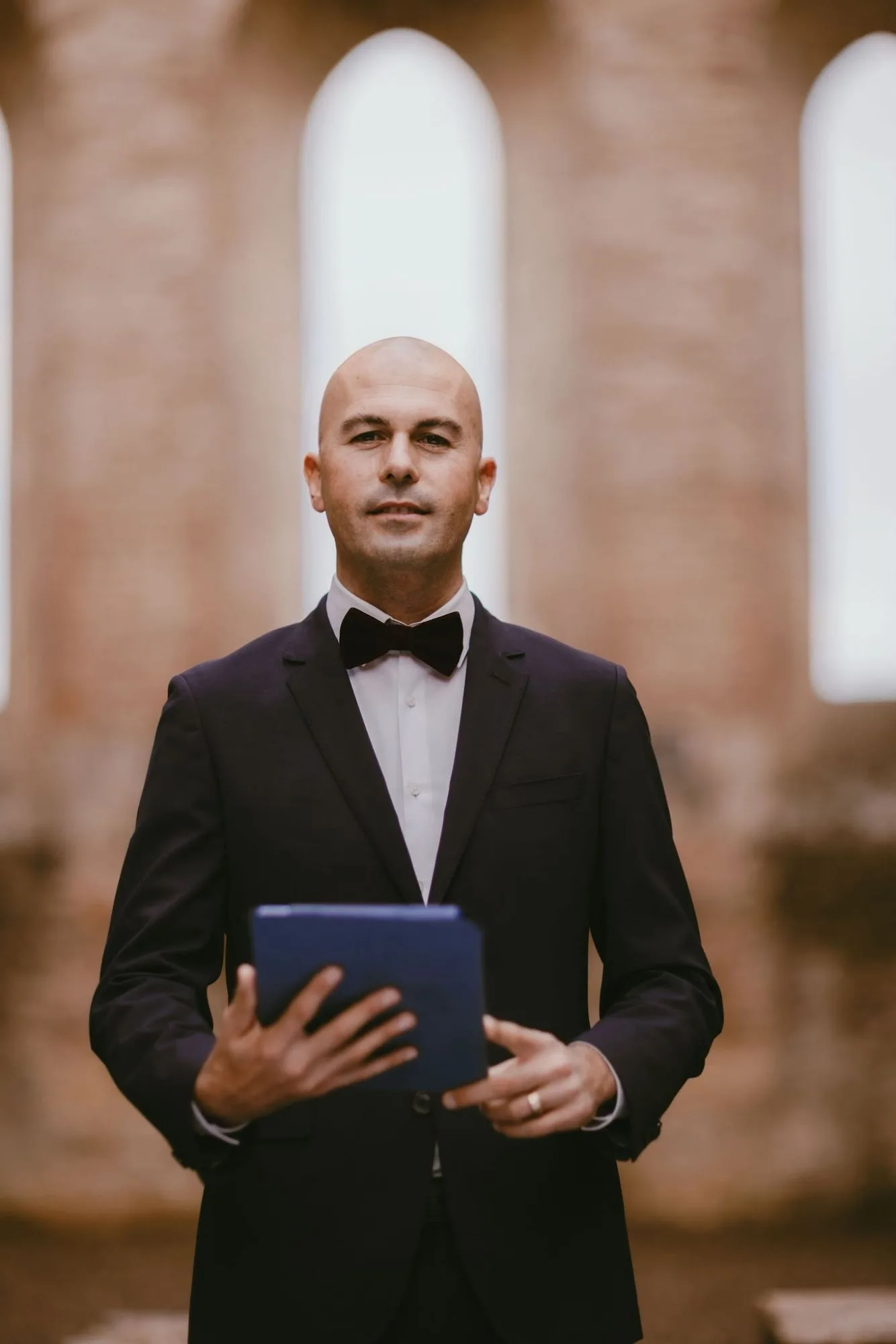 Filippo Filippo, IWC wedding celebrant in Florence, holding his ceremony folder